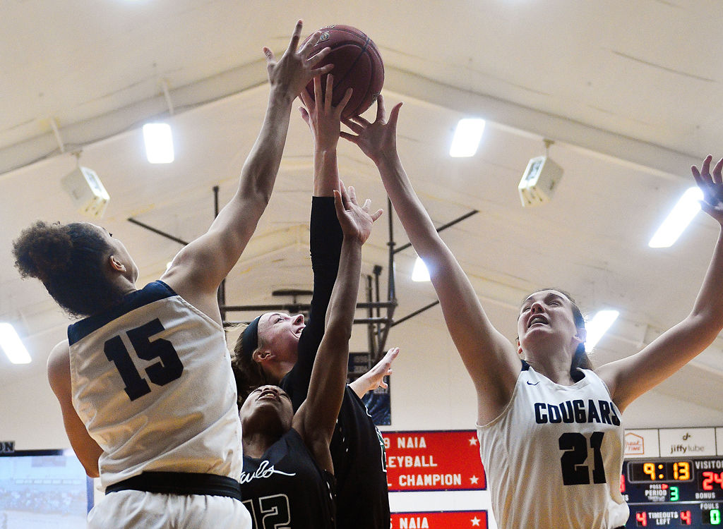 Geena Stephens and Mai Nienhueser fight for the ball against Kaycee Gerald and Peyton Greenlee